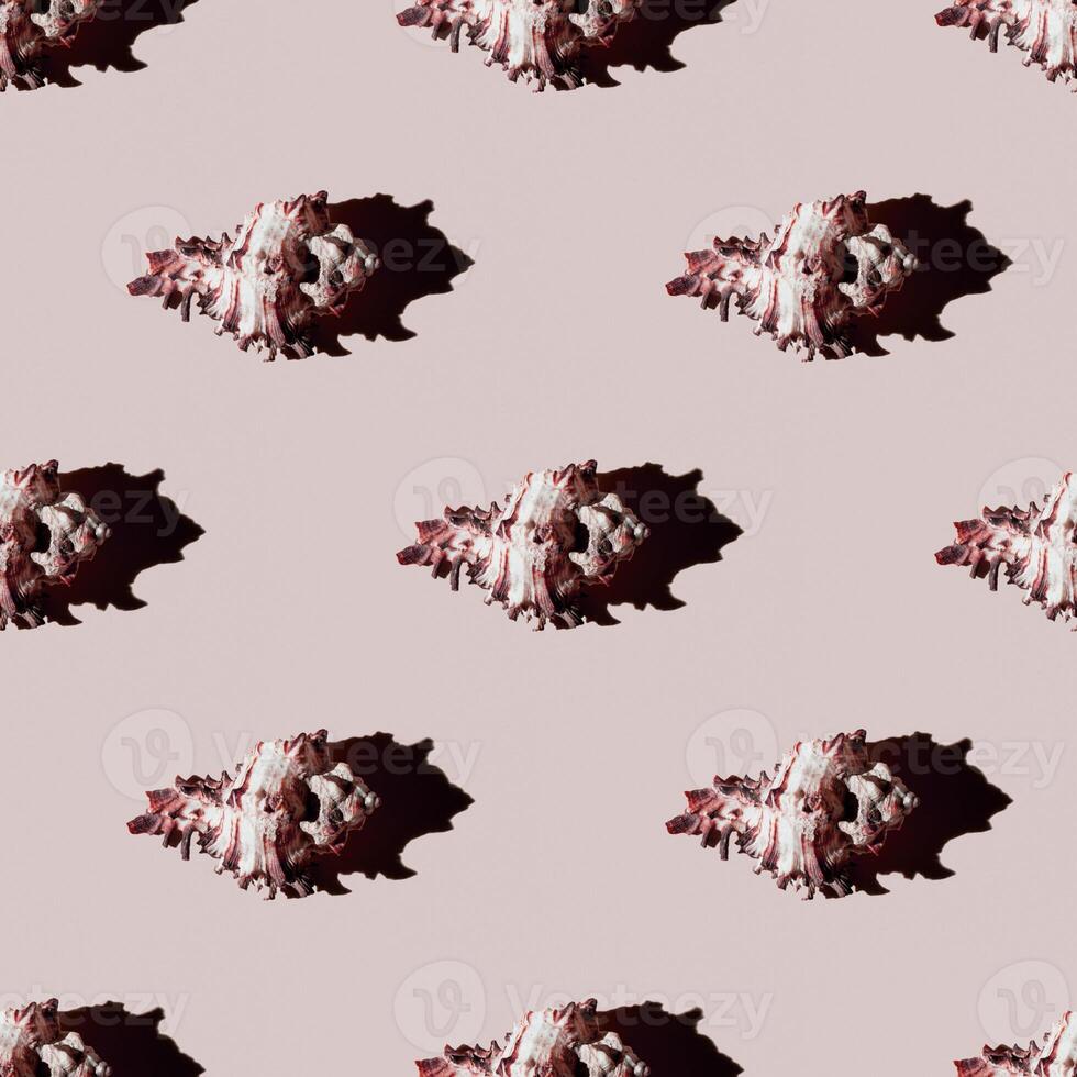 Seamless pattern of clam shells on a pastel yellow background. photo