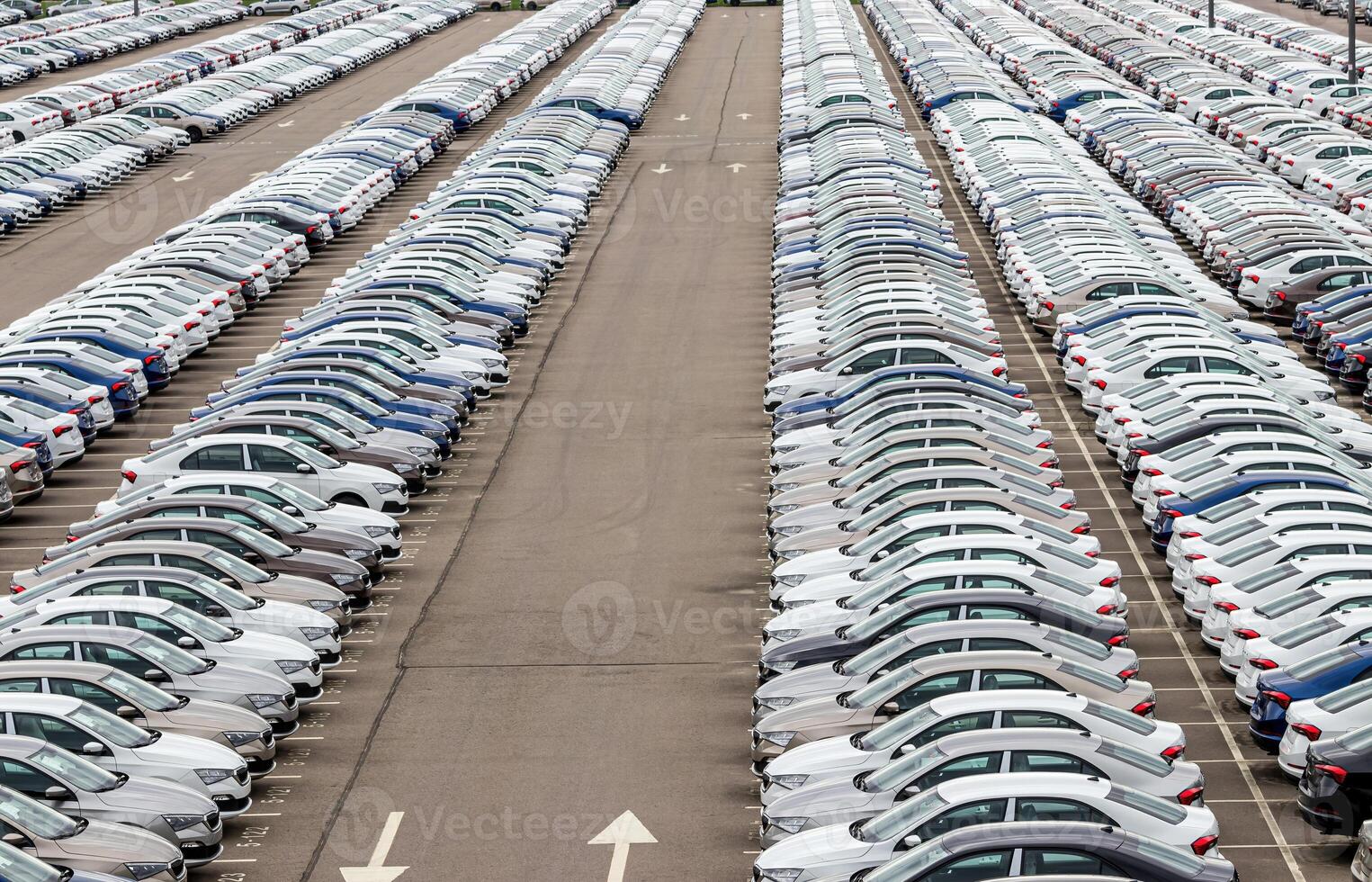 Rows of a new cars parked in a distribution center of a car factory. photo