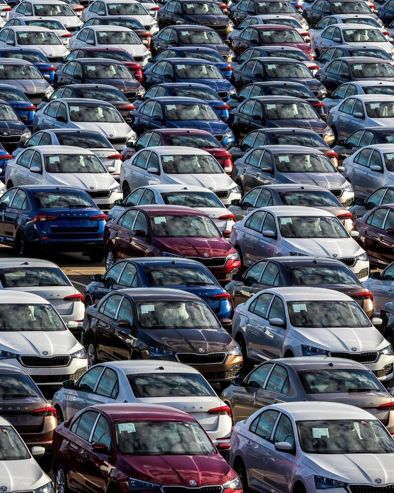 Volkswagen Group Rus, Russia, Kaluga - MAY 25, 2020 Rows of a new cars parked in a distribution center on a sunny day in the sprin. photo