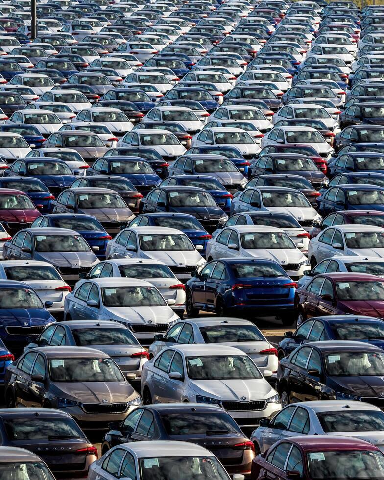Volkswagen Group Rus, Russia, Kaluga - MAY 25, 2020 Rows of a new cars parked in a distribution center on a sunny day in the sprin. photo