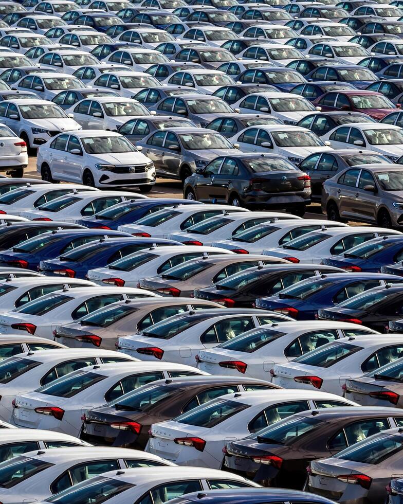 Volkswagen Group Rus, Russia, Kaluga - MAY 25, 2020 Rows of a new cars parked in a distribution center on a sunny day in the sprin. photo