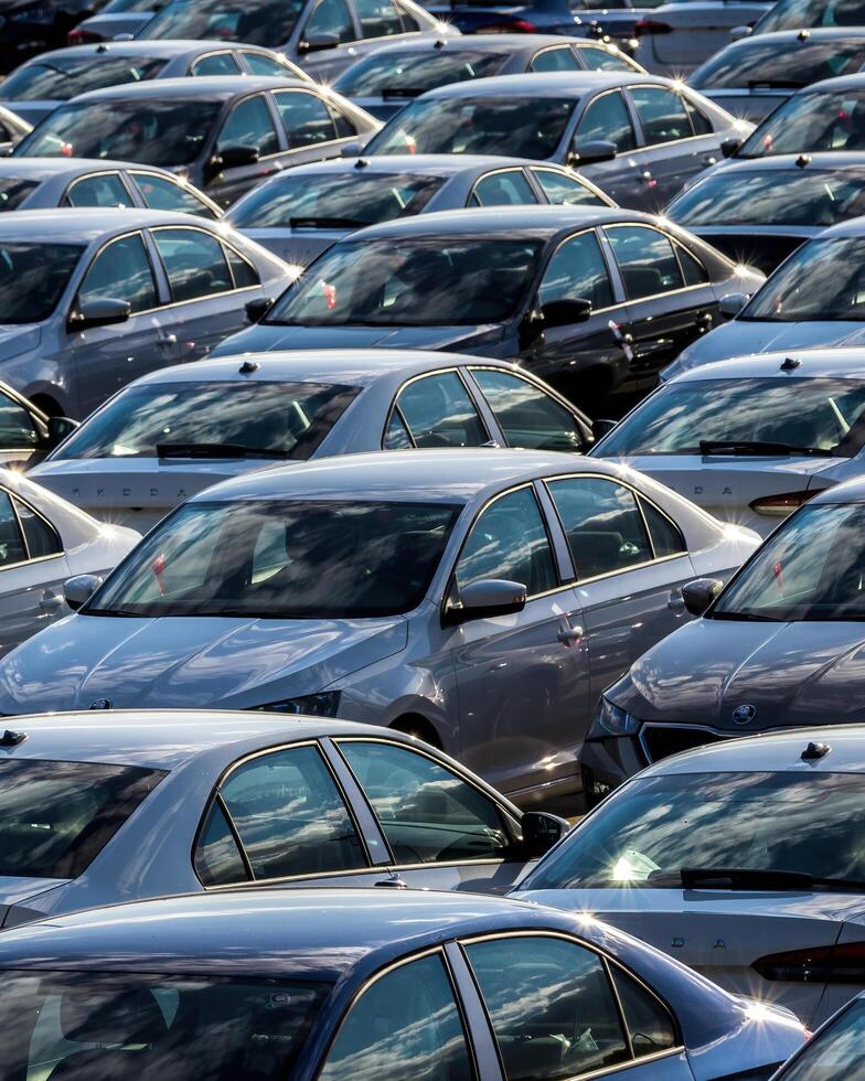 Volkswagen Group Rus, Russia, Kaluga - MAY 25, 2020 Rows of a new cars parked in a distribution center on a sunny day in the sprin. photo
