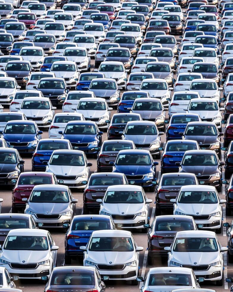 Volkswagen Group Rus, Russia, Kaluga - MAY 25, 2020 Rows of a new cars parked in a distribution center on a sunny day in the spring photo