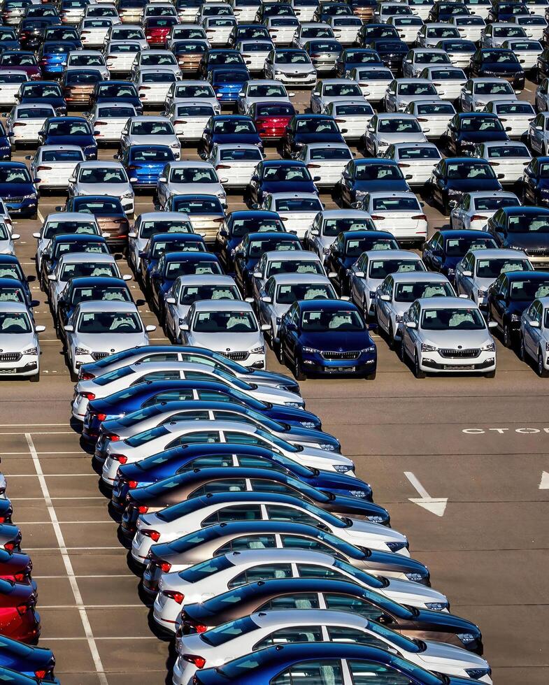 Volkswagen Group Rus, Russia, Kaluga - MAY 25, 2020 Rows of a new cars parked in a distribution center on a sunny day in the spring photo