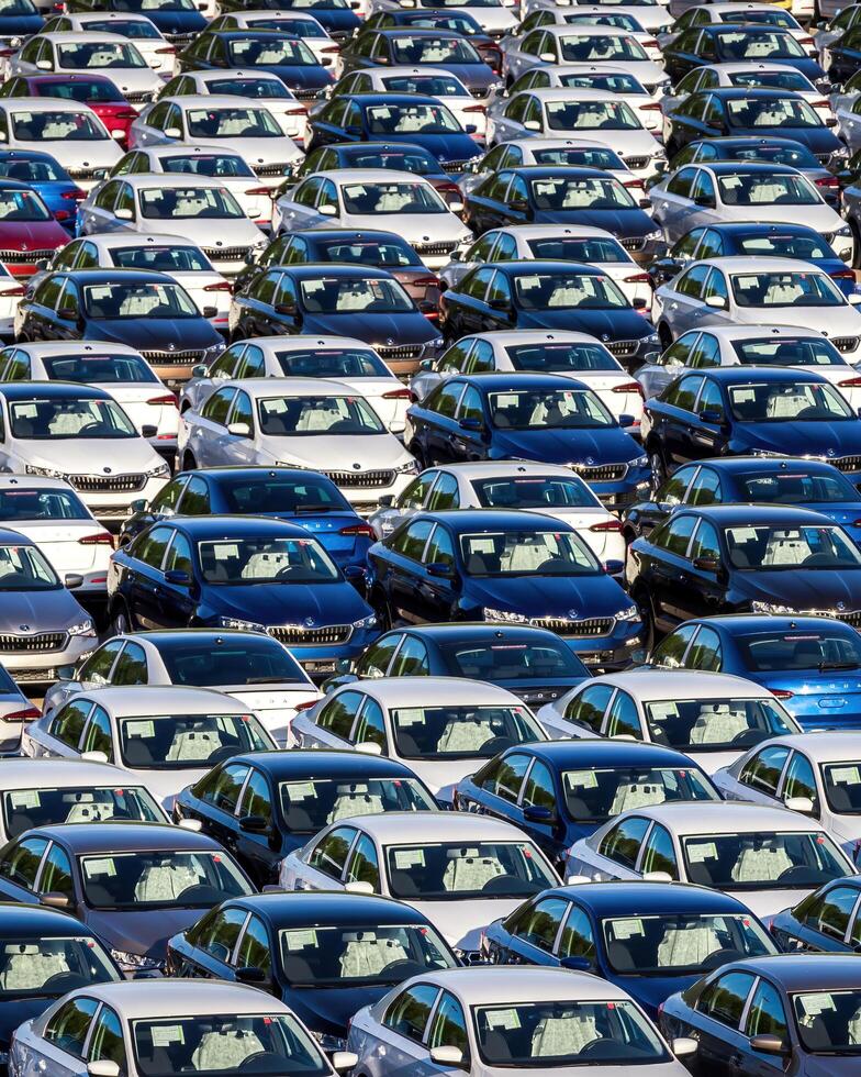 Volkswagen Group Rus, Russia, Kaluga - MAY 25, 2020 Rows of a new cars parked in a distribution center on a sunny day in the spring photo