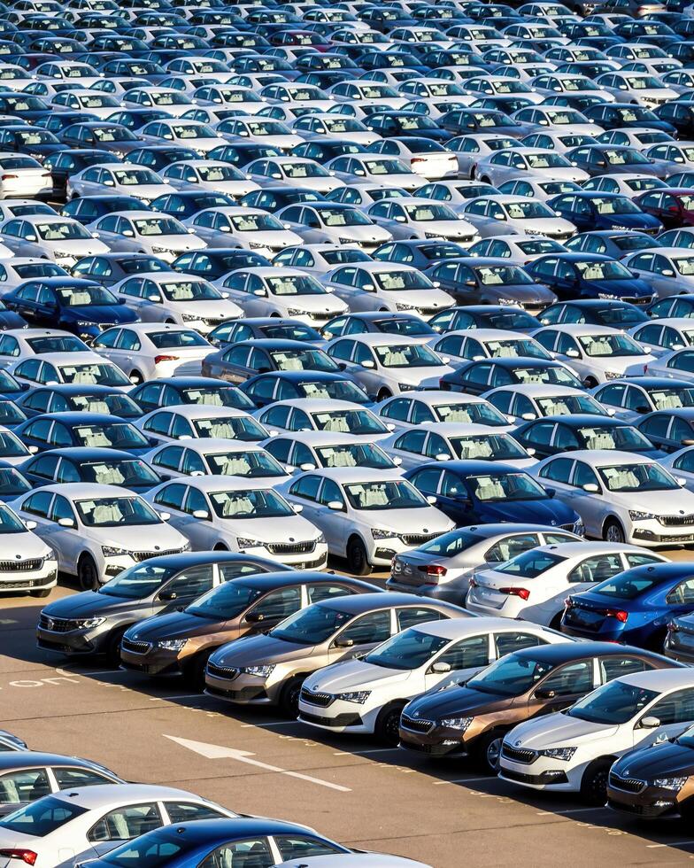 Volkswagen Group Rus, Russia, Kaluga - MAY 25, 2020 Rows of a new cars parked in a distribution center on a sunny day in the spring photo