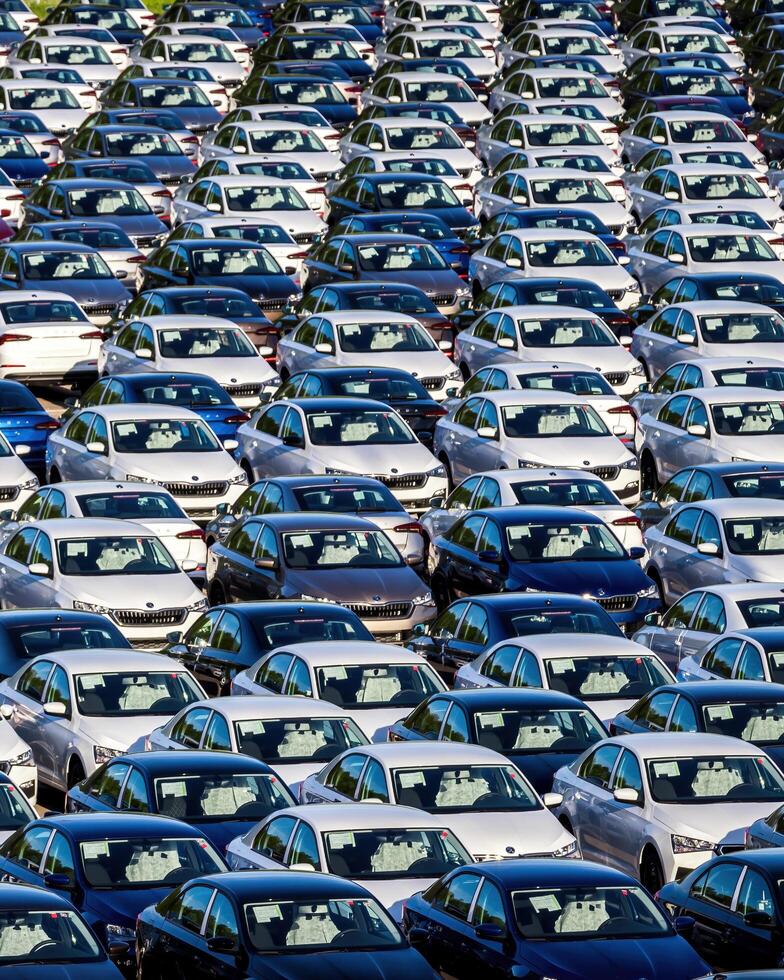 Volkswagen Group Rus, Russia, Kaluga - MAY 25, 2020 Rows of a new cars parked in a distribution center on a sunny day in the spring photo