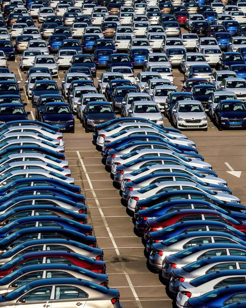 Volkswagen Group Rus, Russia, Kaluga - MAY 25, 2020 Rows of a new cars parked in a distribution center on a sunny day in the spring photo