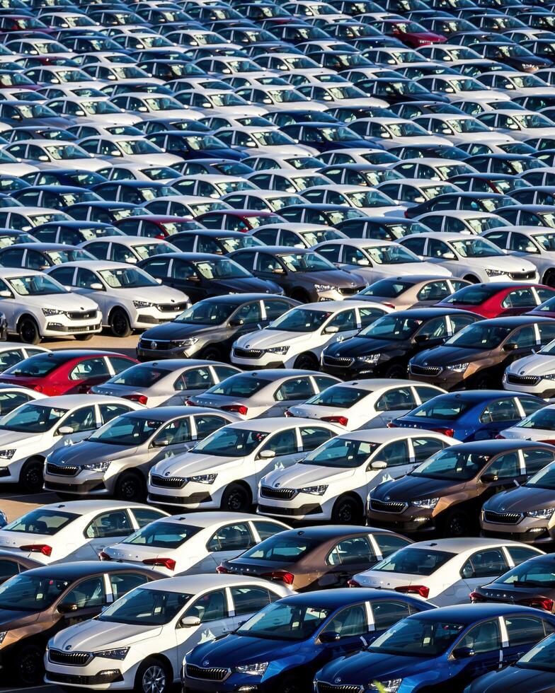 Volkswagen Group Rus, Russia, Kaluga - MAY 25, 2020 Rows of a new cars parked in a distribution center on a sunny day in the spring photo