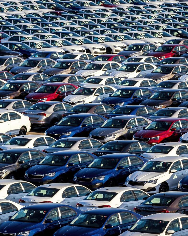Volkswagen Group Rus, Russia, Kaluga - MAY 25, 2020 Rows of a new cars parked in a distribution center on a sunny day in the spring photo