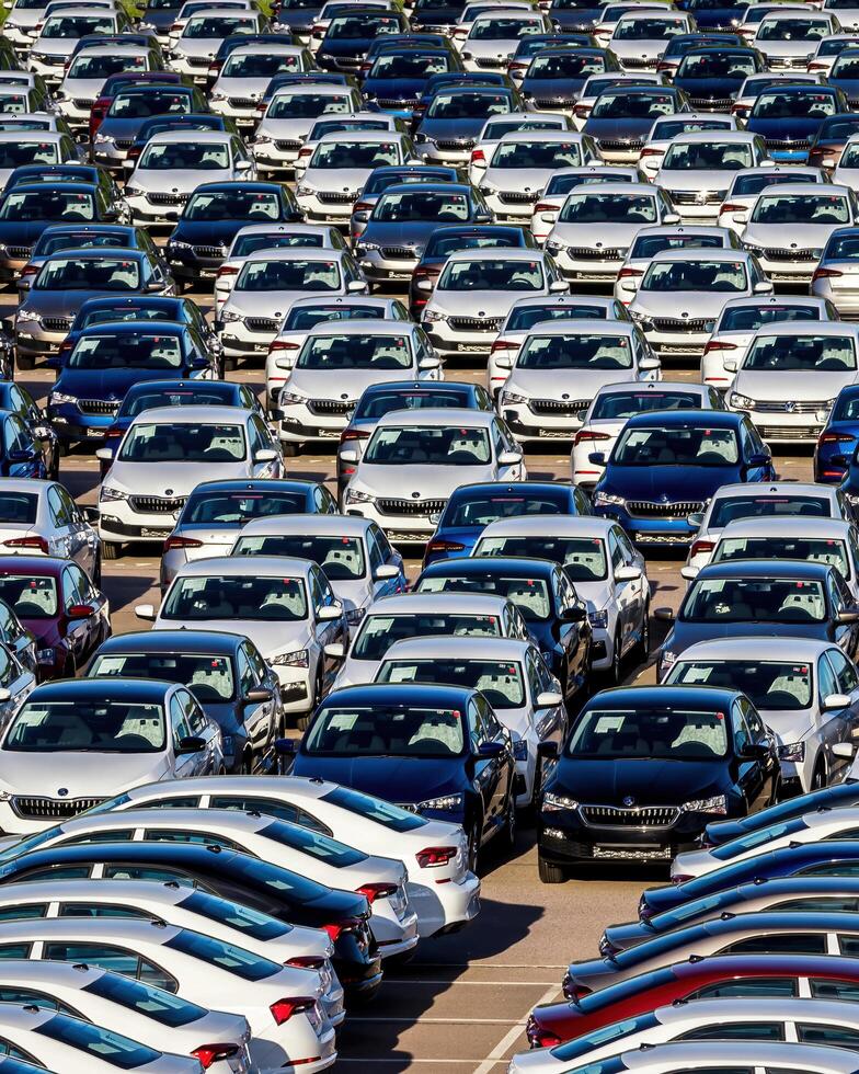 Volkswagen Group Rus, Russia, Kaluga - MAY 25, 2020 Rows of a new cars parked in a distribution center on a sunny day in the spring photo