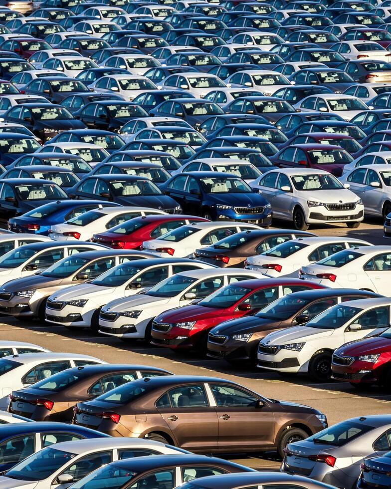 Volkswagen Group Rus, Russia, Kaluga - MAY 25, 2020 Rows of a new cars parked in a distribution center on a sunny day in the spring photo