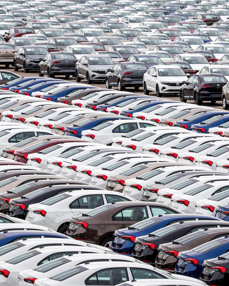 Volkswagen Group Rus, Russia, Kaluga - MAY 24, 2020 Rows of a new cars parked in a distribution center on a cloudy day in the spring, a car factory photo