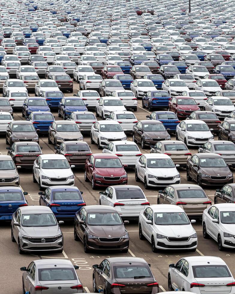 Volkswagen Group Rus, Russia, Kaluga - MAY 24, 2020 Rows of a new cars parked in a distribution center on a cloudy day in the spring, a car factory photo