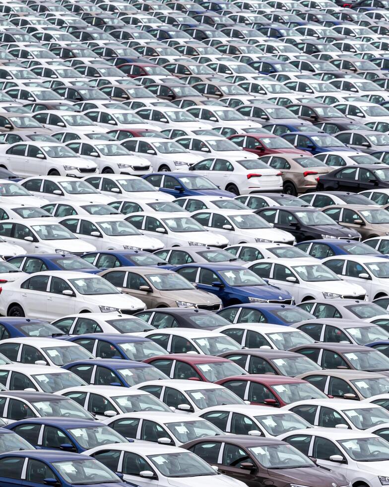 Volkswagen Group Rus, Russia, Kaluga - MAY 24, 2020 Rows of a new cars parked in a distribution center on a cloudy day in the spring, a car factory photo