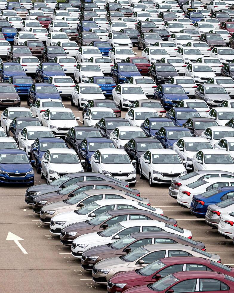 Volkswagen Group Rus, Russia, Kaluga - MAY 24, 2020 Rows of a new cars parked in a distribution center on a cloudy day in the spring, a car factory photo