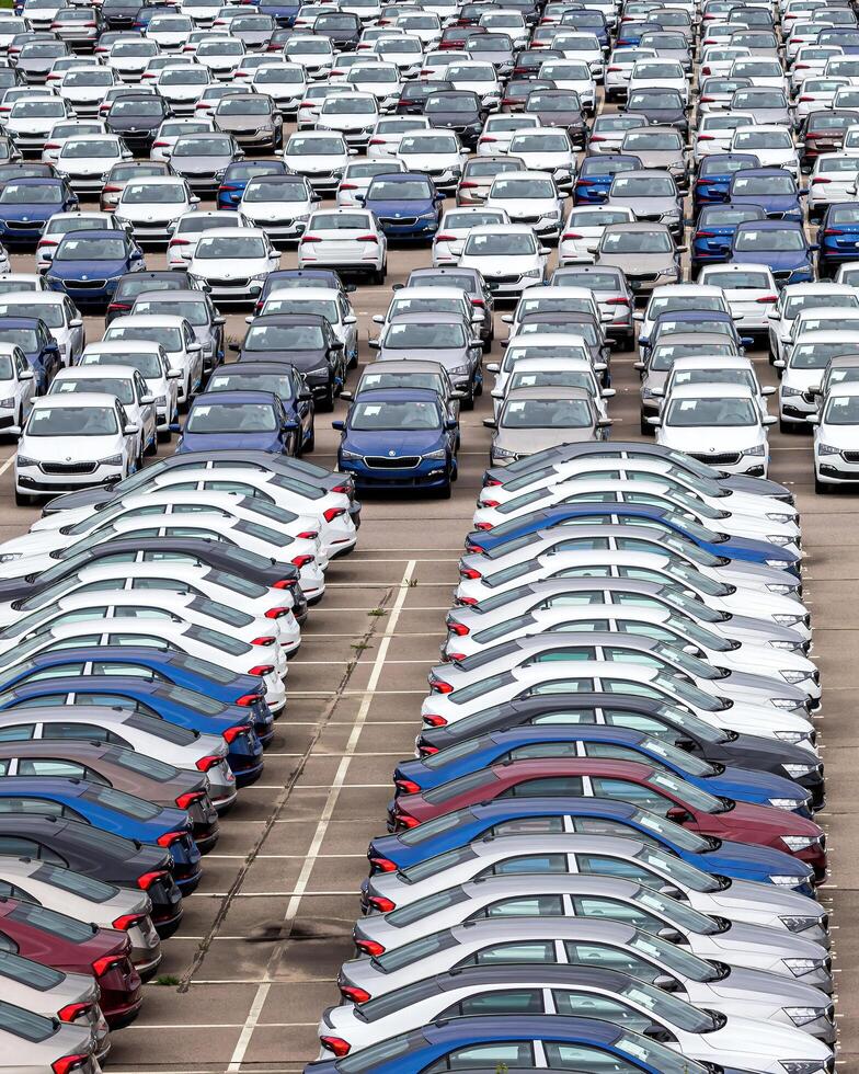 Volkswagen Group Rus, Russia, Kaluga - MAY 24, 2020 Rows of a new cars parked in a distribution center on a cloudy day in the spring, a car factory photo