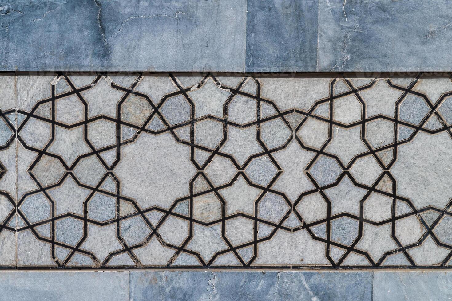 Geometric traditional Islamic ornament. Fragment of a ceramic mosaic. photo