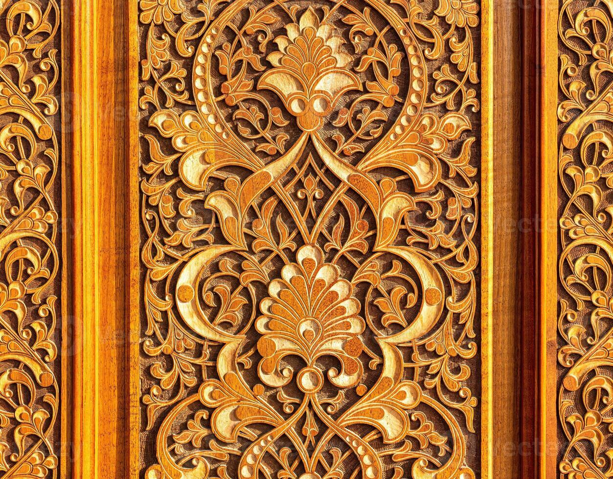 Fragment of an ancient carved wooden door. Ornate. photo