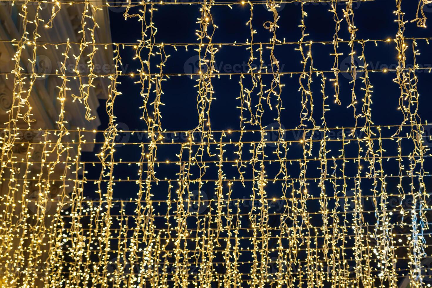 Festive hanging LED garlands against the background of the night sky. photo