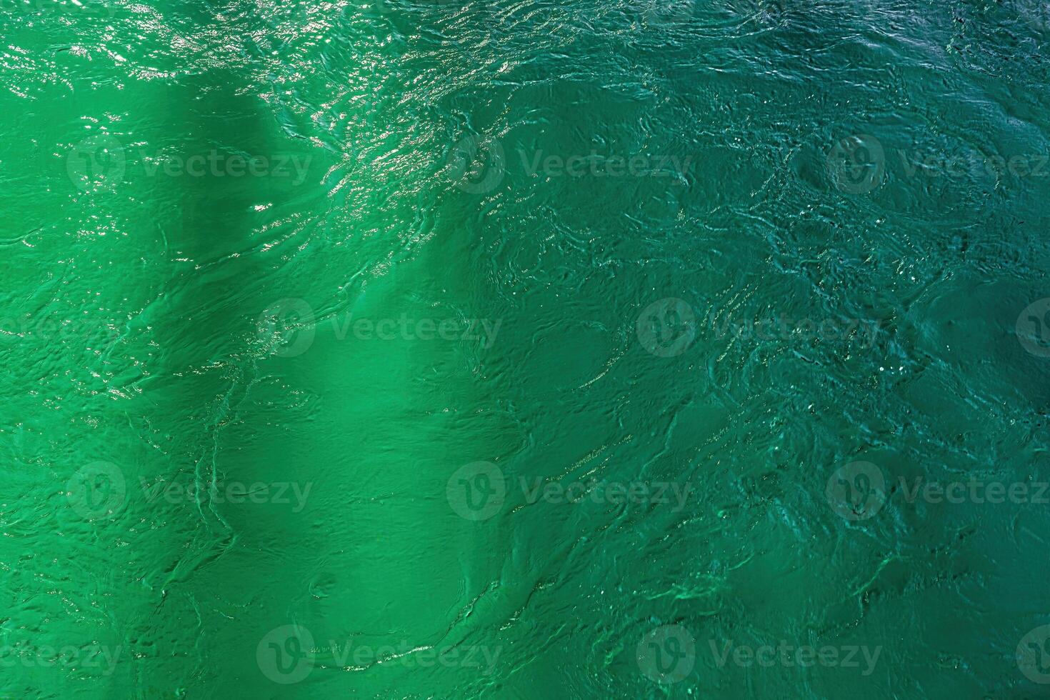 The texture of the waves of turquoise color of fast-flowing water in the river. photo