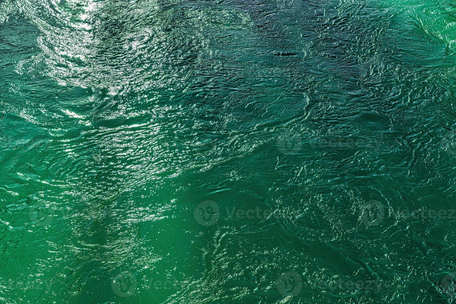 The texture of the waves of turquoise color of fast-flowing water in the river. photo