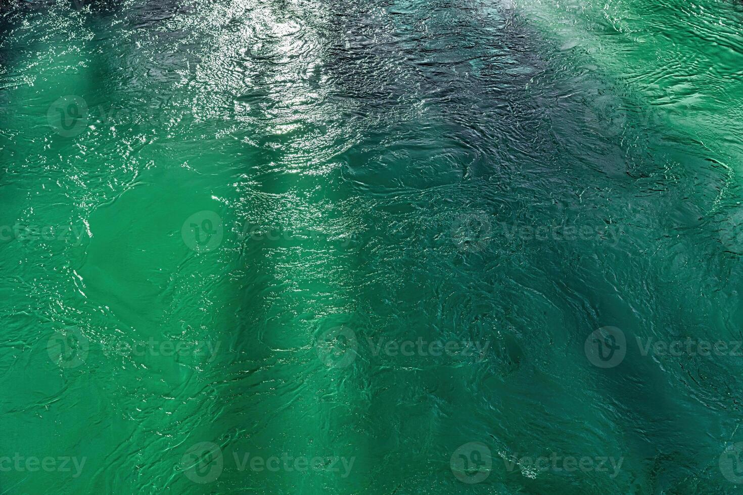 The texture of the waves of turquoise color of fast-flowing water in the river. photo