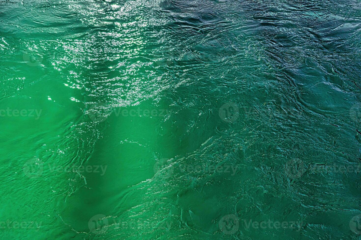 The texture of the waves of turquoise color of fast-flowing water in the river. photo