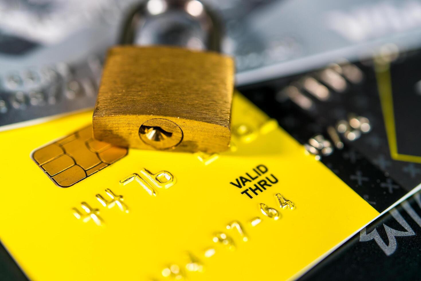 Russia, Kaluga - JULY 11, 2022 Debit or credit card with lock. The concept of security, protection or blocking of funds on the card. photo