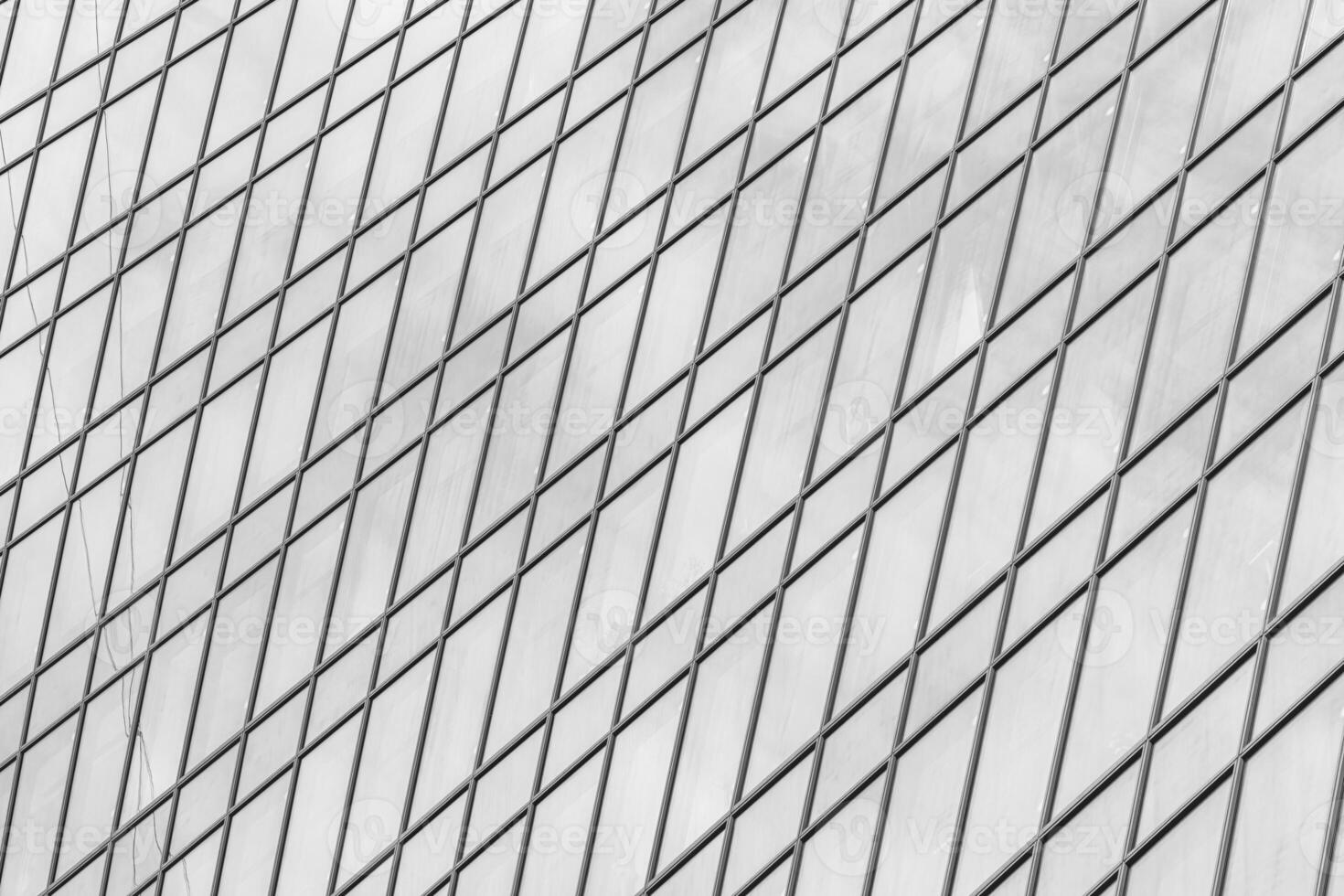 Fragment of a modern office building. Abstract geometric background. Part of a skyscraper with glass windows. Black and white. photo