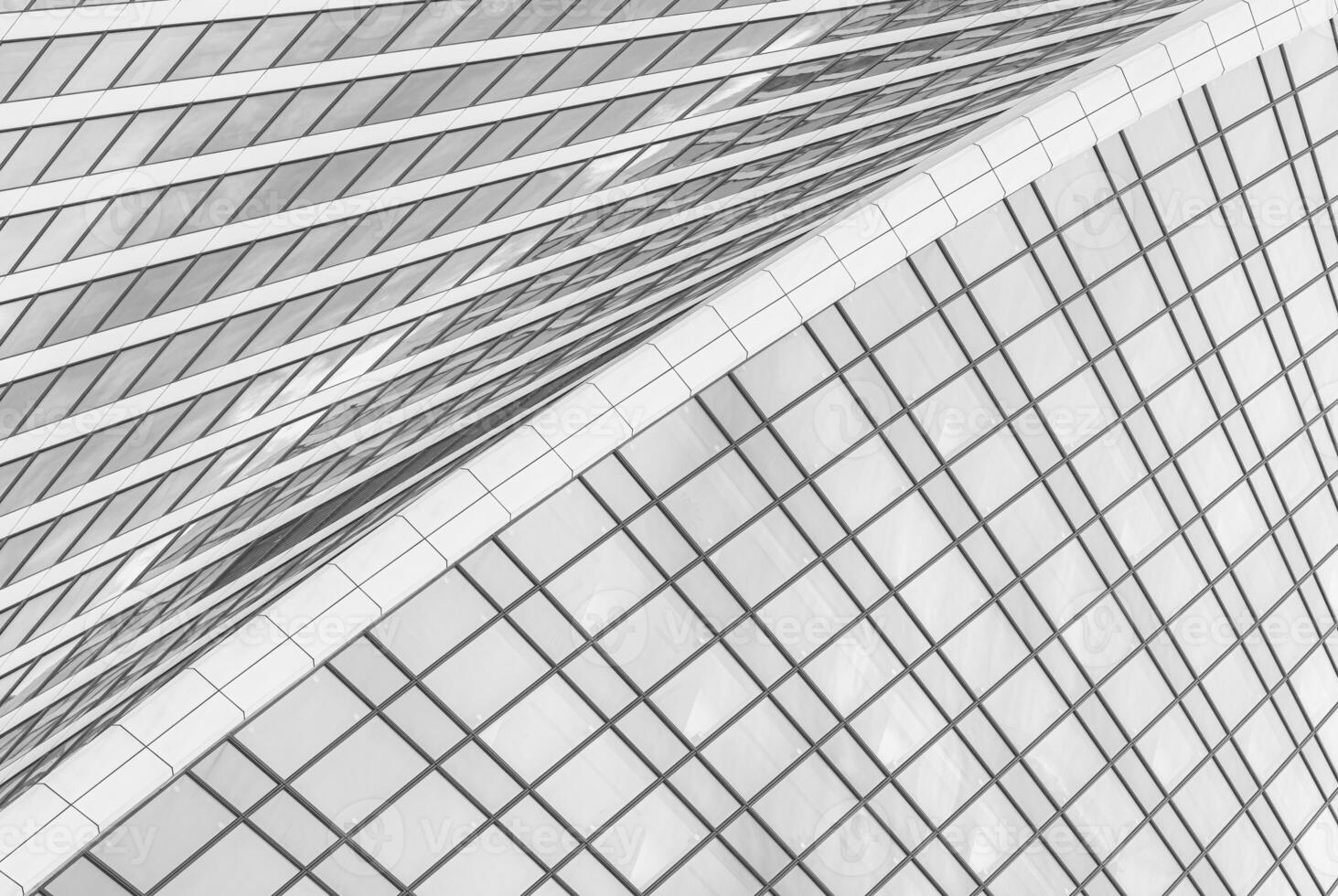 Fragment of a modern office building. Abstract geometric background. Part of a skyscraper with glass windows. Black and white. photo