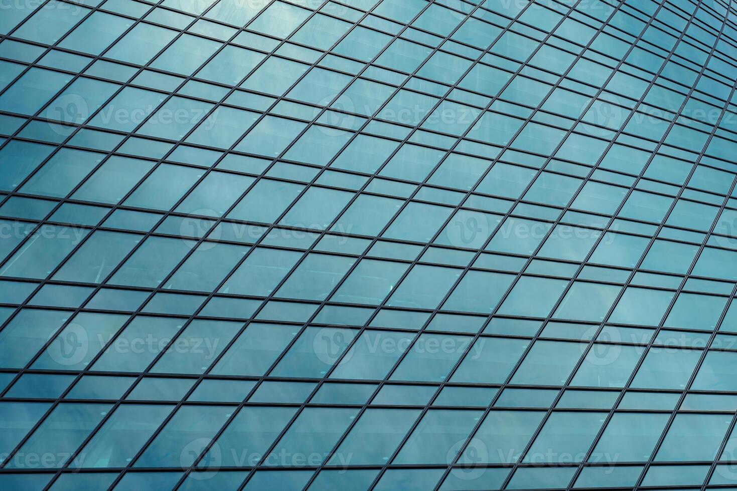 Fragment of a modern office building. Abstract geometric background. Part of a skyscraper with glass windows. photo