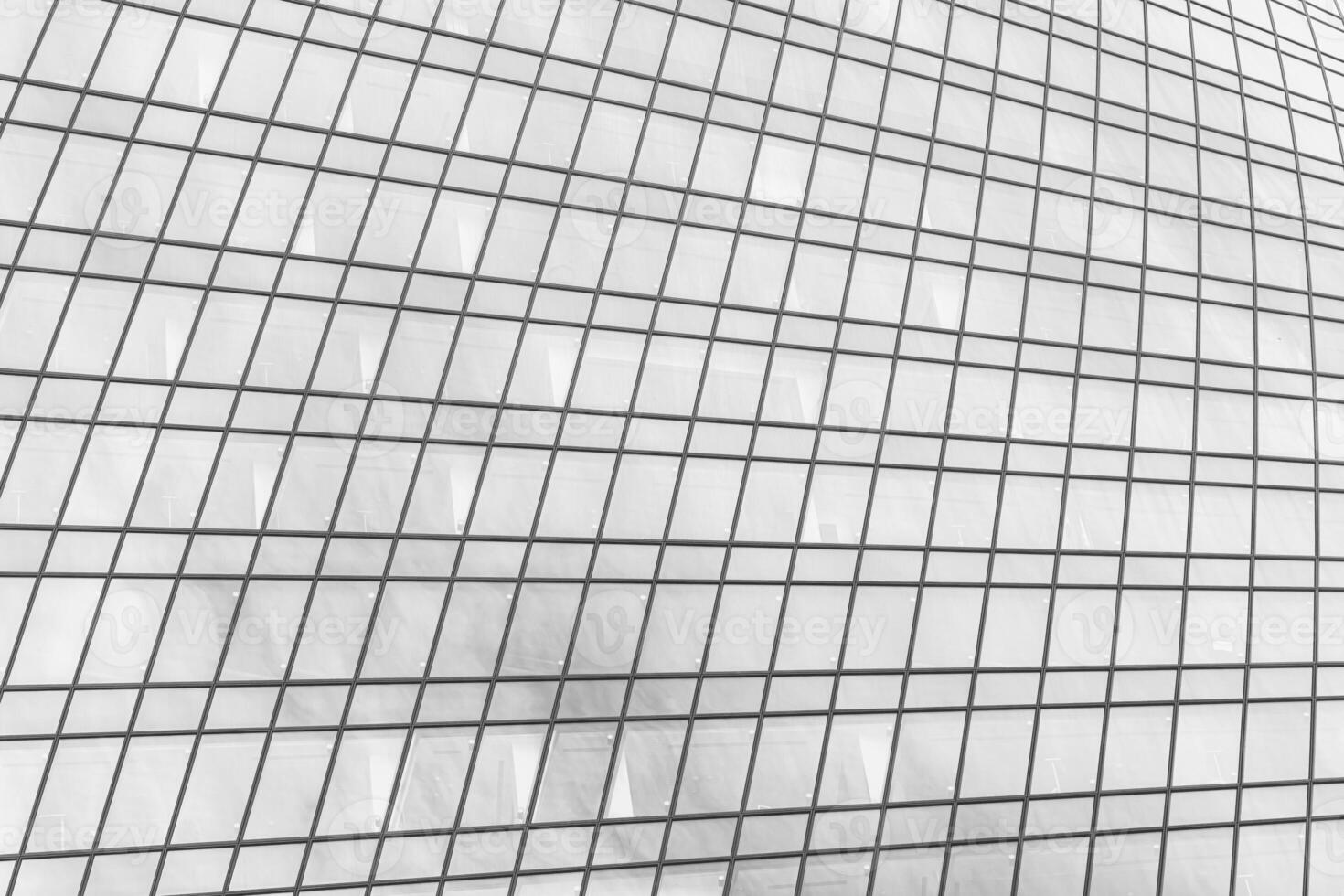 Fragment of a modern office building. Abstract geometric background. Part of a skyscraper with glass windows. Black and white. photo