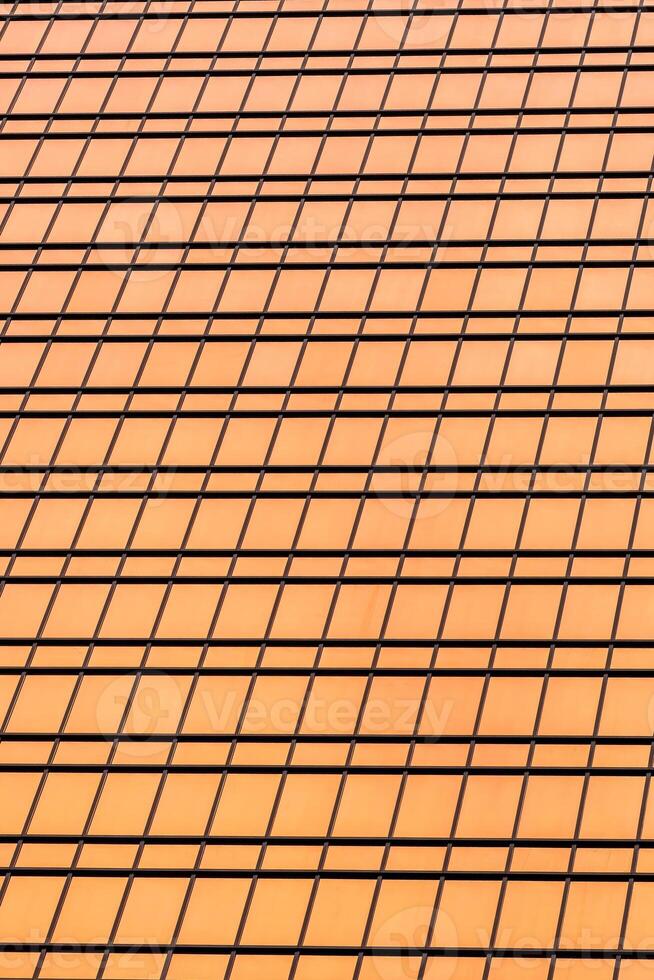 Fragment of a modern office building. Abstract geometric background. Part of a skyscraper with glass windows. photo