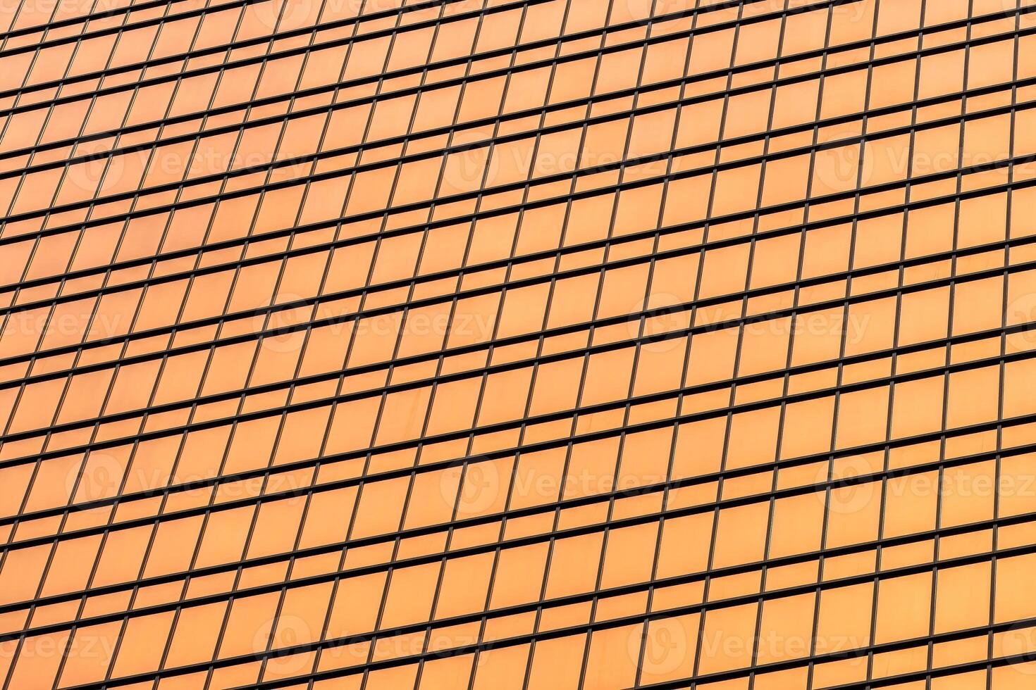 Fragment of a modern office building. Abstract geometric background. Part of a skyscraper with glass windows. photo