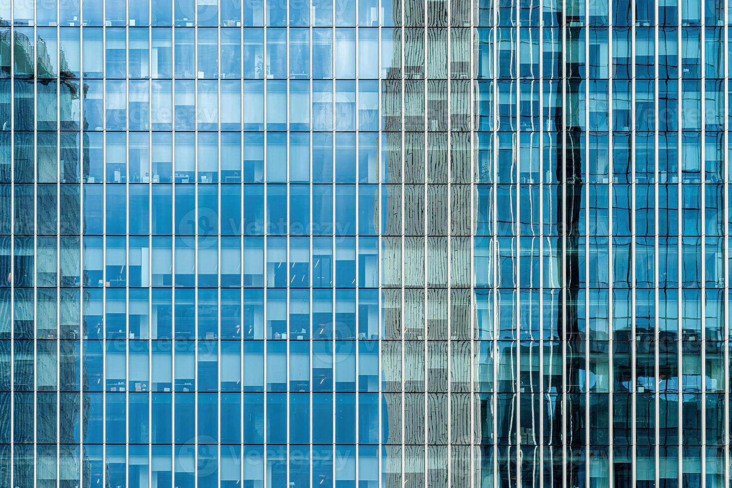 Fragment of a modern office building. Abstract geometric background. Part of a skyscraper with glass windows. photo