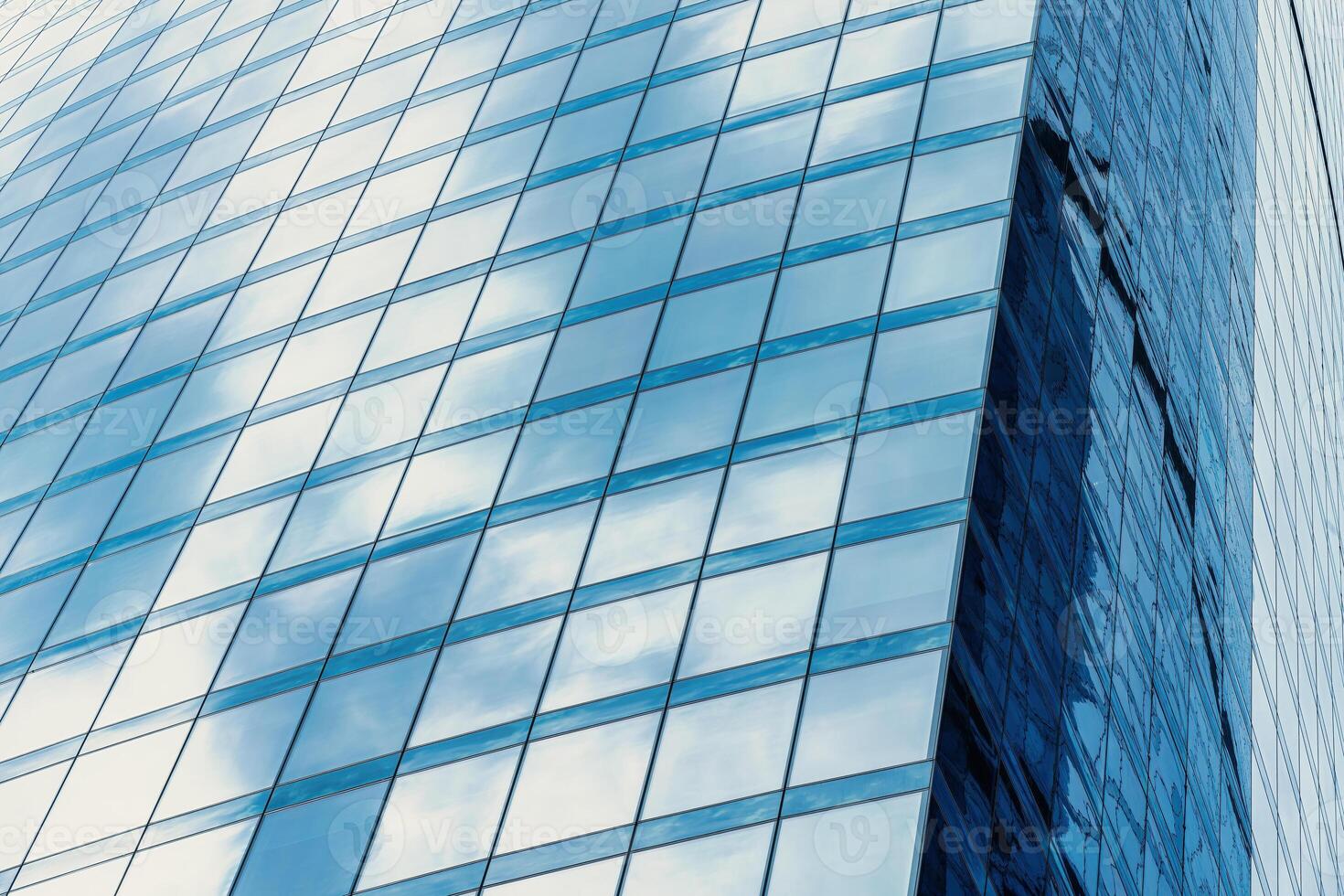 Fragment of a modern office building. Abstract geometric background. Part of a skyscraper with glass windows. photo