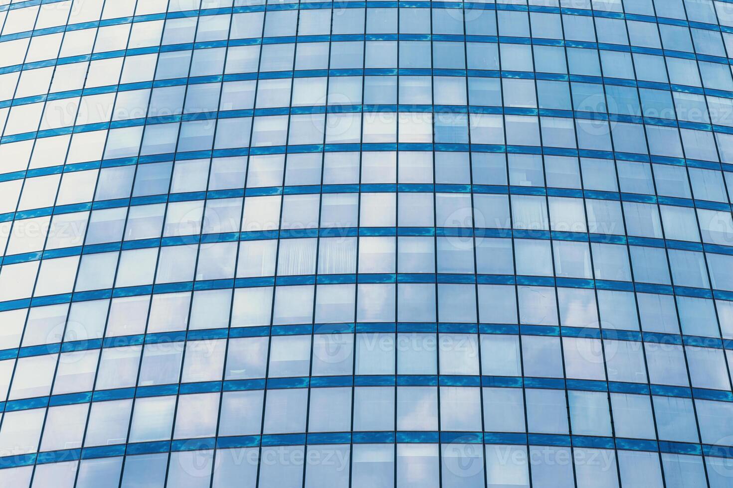 Fragment of a modern office building. Abstract geometric background. Part of a skyscraper with glass windows. photo