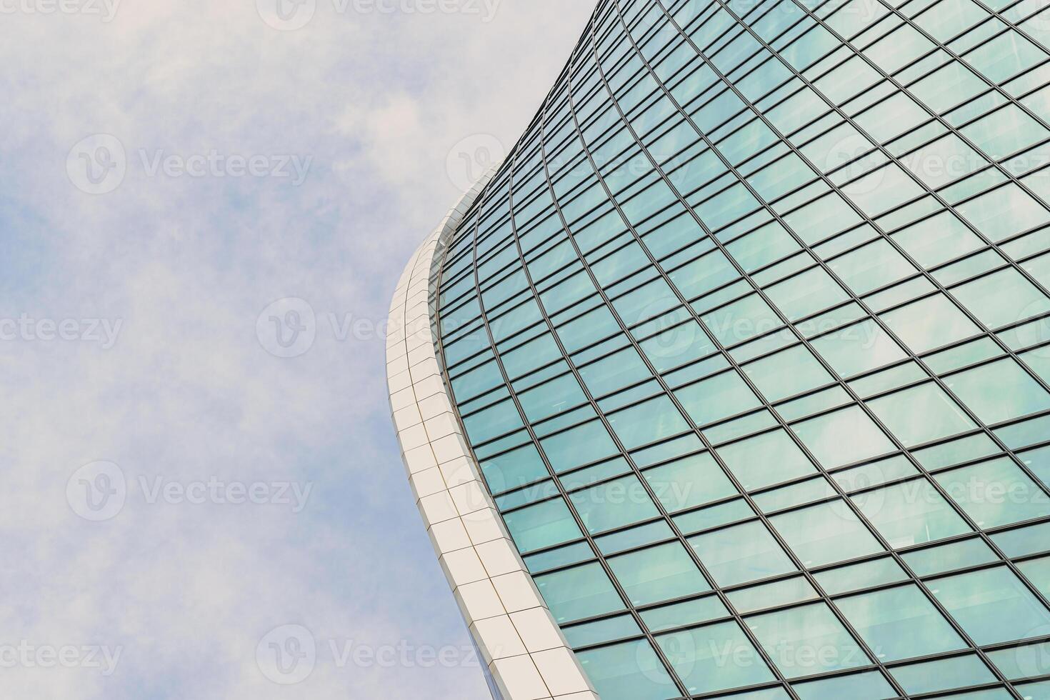 Fragment of a modern office building. Abstract geometric background. Part of a skyscraper with glass windows. photo