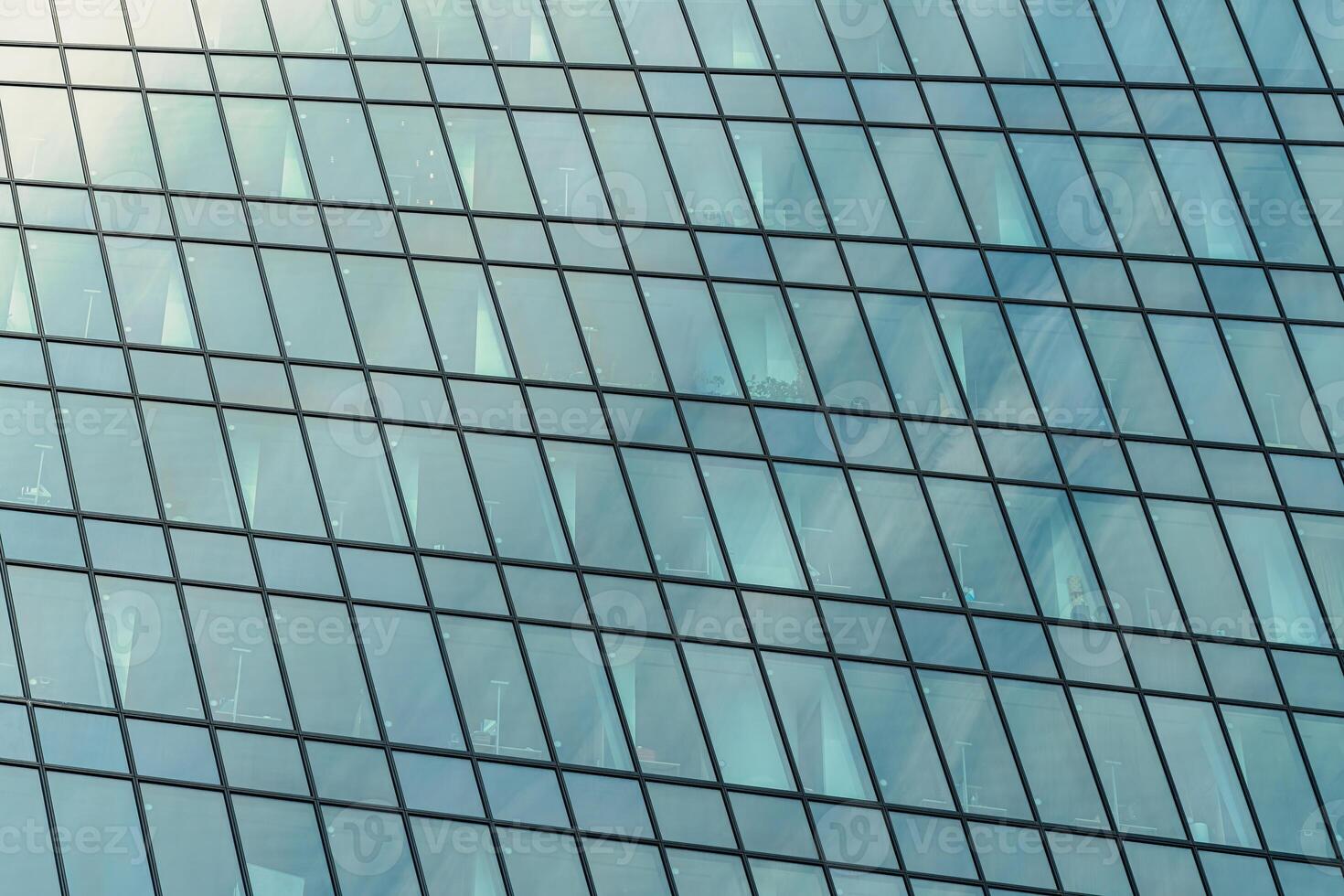 Fragment of a modern office building. Abstract geometric background. Part of a skyscraper with glass windows. photo