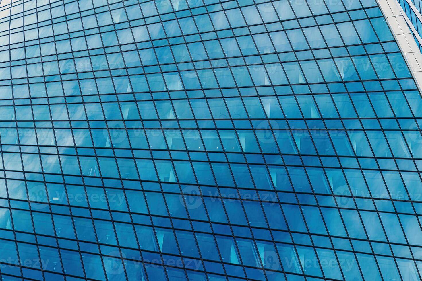 Fragment of a modern office building. Abstract geometric background. Part of a skyscraper with glass windows. photo