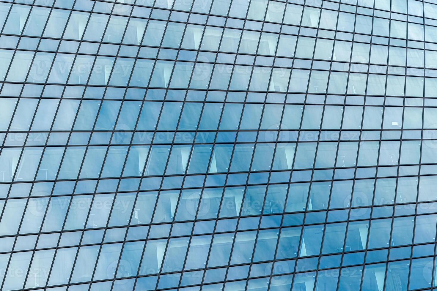 Fragment of a modern office building. Abstract geometric background. Part of a skyscraper with glass windows. photo