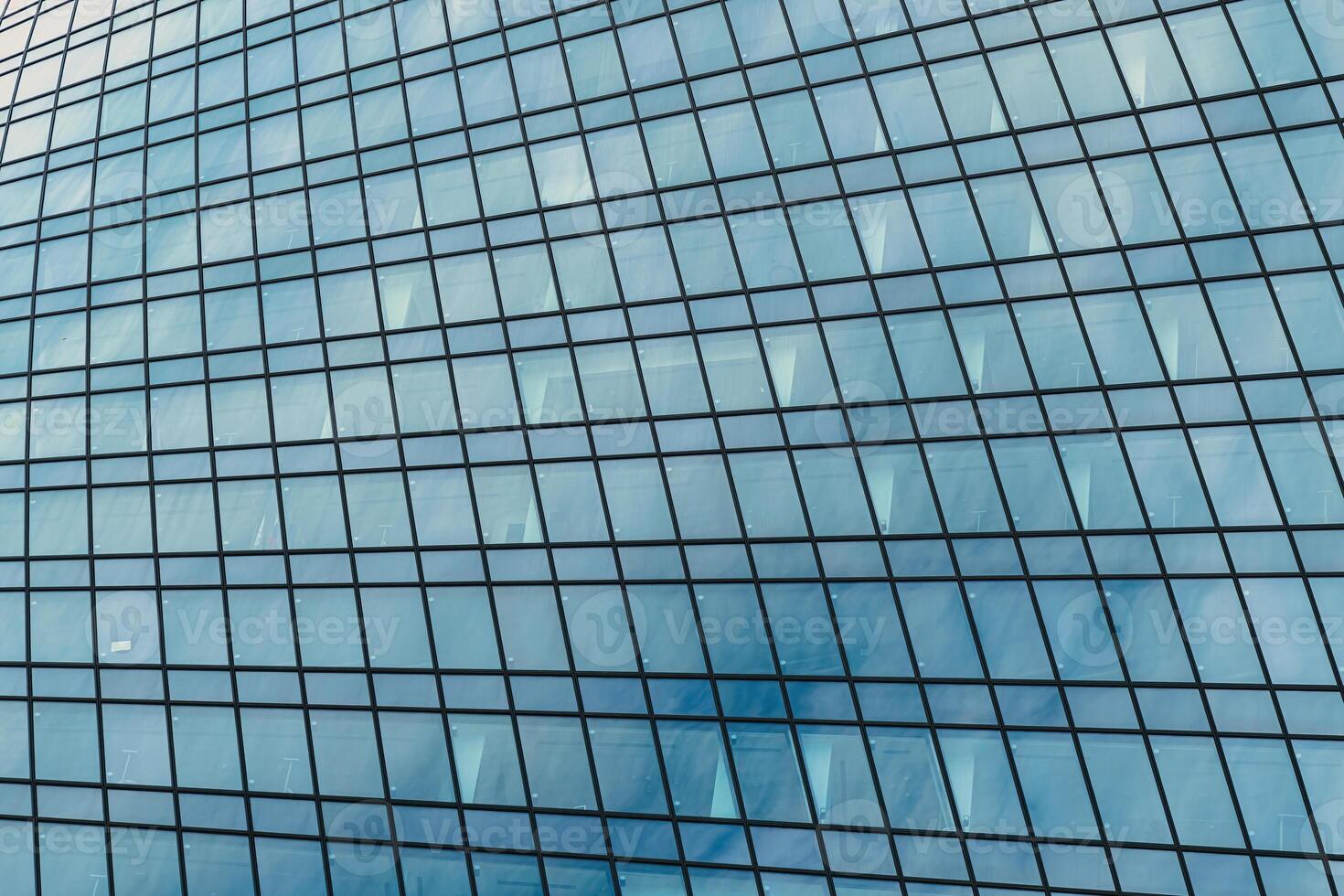 Fragment of a modern office building. Abstract geometric background. Part of a skyscraper with glass windows. photo