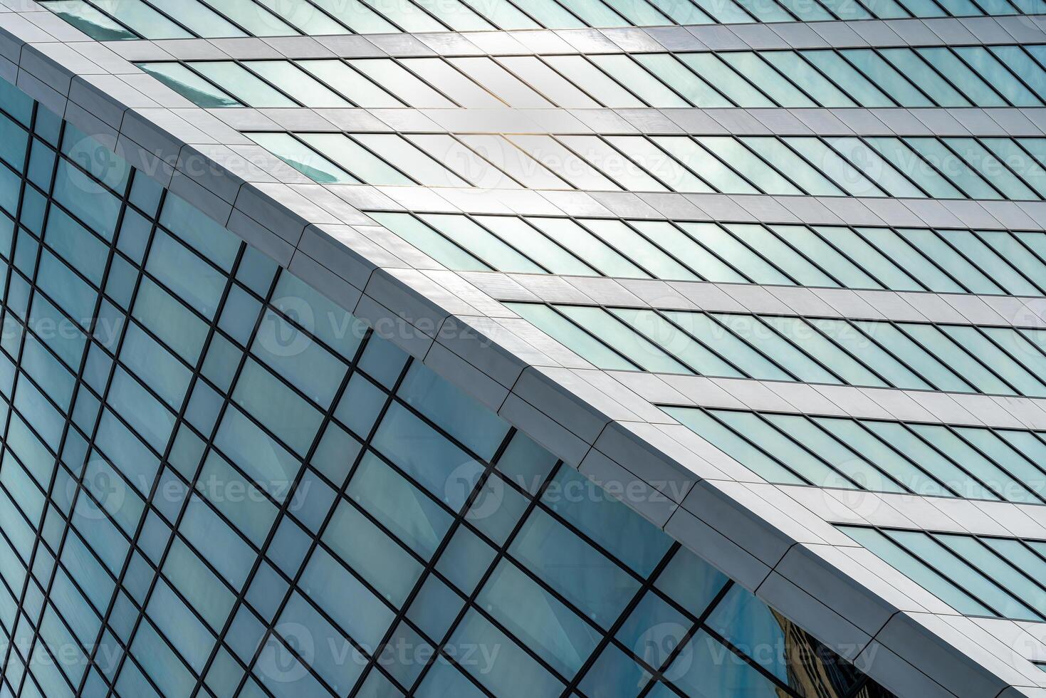 Fragment of a modern office building. Abstract geometric background. Part of a skyscraper with glass windows. photo