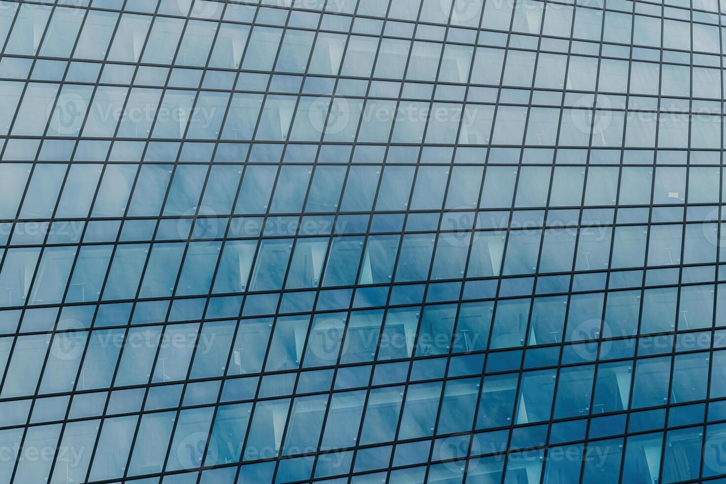 Fragment of a modern office building. Abstract geometric background. Part of a skyscraper with glass windows. photo