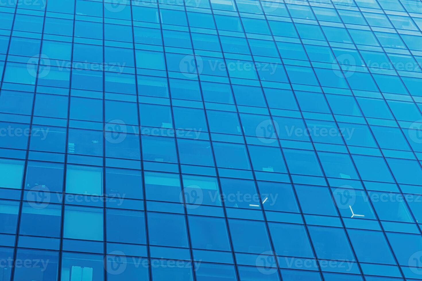 Fragment of a modern office building. Abstract geometric background. Part of a skyscraper with glass windows. photo