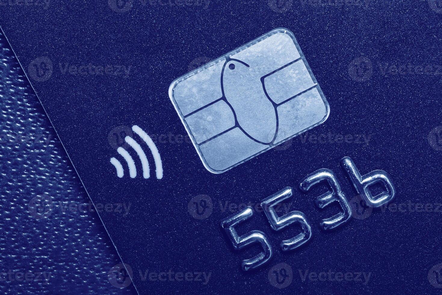 Close-up shot of a debit or credit card with a chip. photo