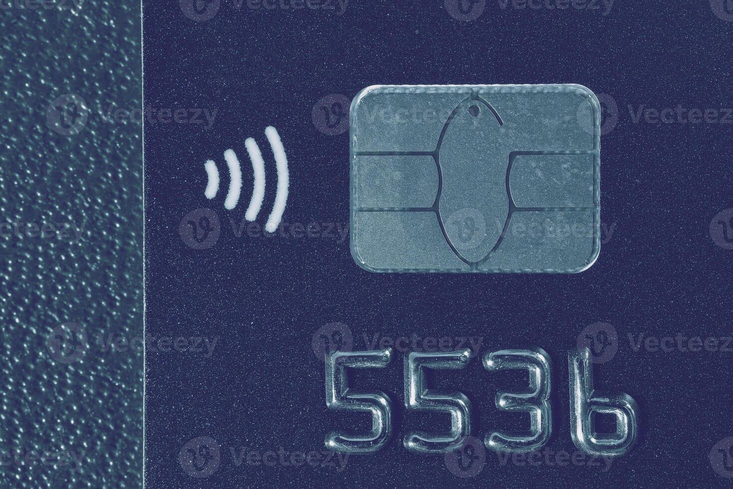 Close-up shot of a debit or credit card with a chip. photo