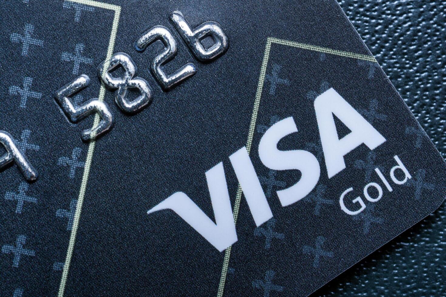 Russia, Kaluga - JULY 11, 2022 Close-up shot of a debit or credit visa card. photo