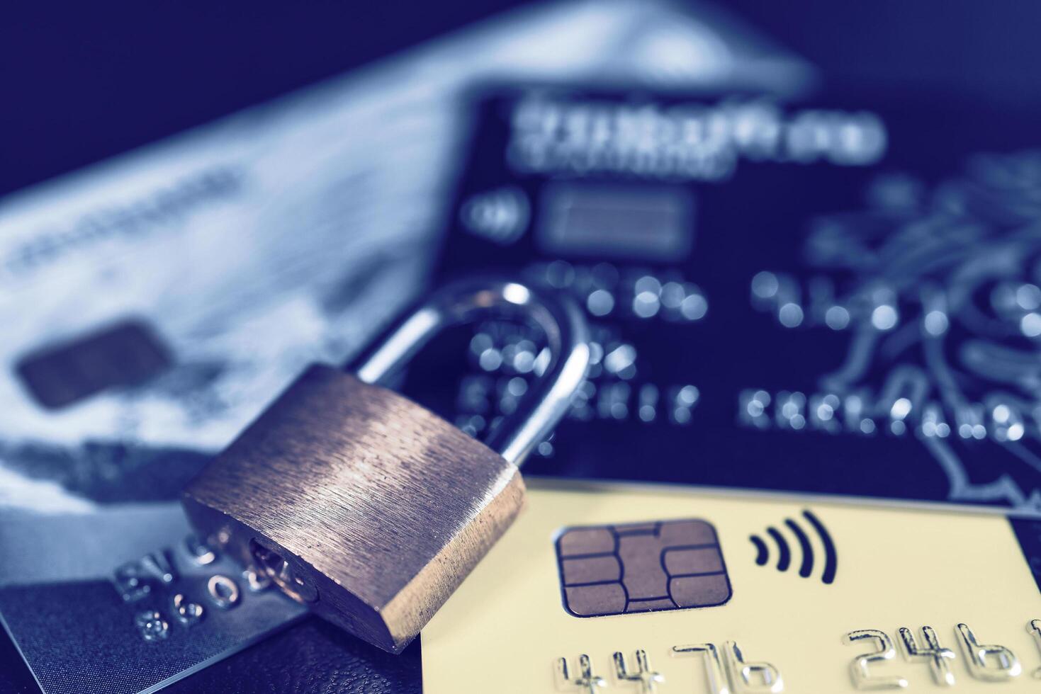 Russia, Kaluga - JULY 11, 2022 Debit or credit card with lock. The concept of security, protection or blocking of funds on the card. photo